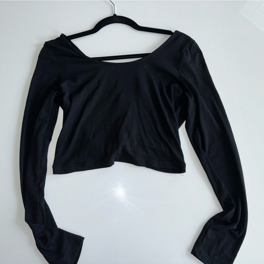 Black crop top with cage netting tie back .